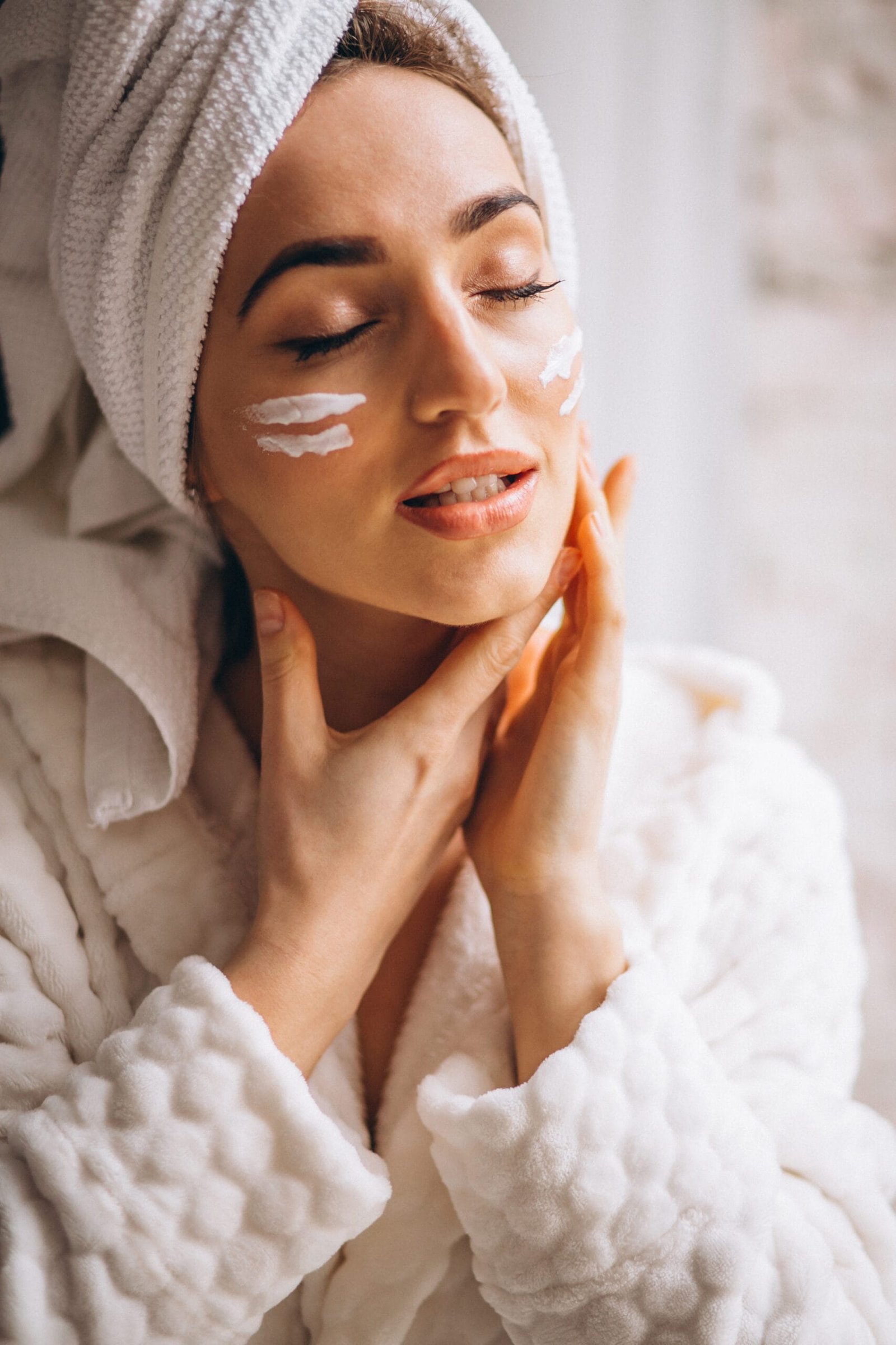 woman applying face cream scaled